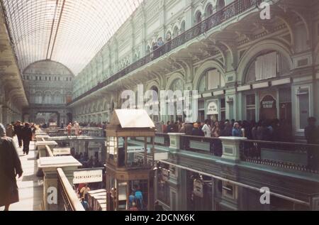 Inside the 1893 GUM Department Store in May 1990 with shoppers waiting in line from items in a store with a glass and steel skylight above. Stock Photo