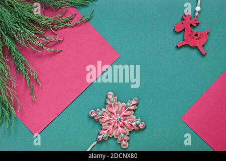 christmas background with ornaments and juniper branches on green and red textured paper Stock Photo