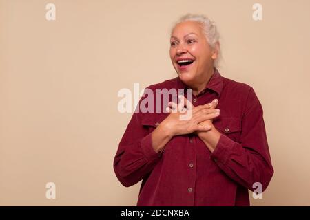 Old hispanic woman with surprised expression on her face Stock Photo
