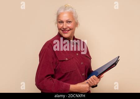 Smiling senior woman smiling looking at camera. Stock Photo