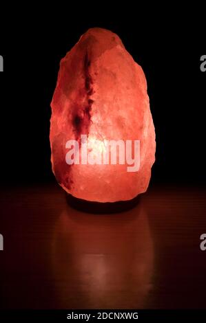 Himalayan Salt Lamp on black background. Stock Photo