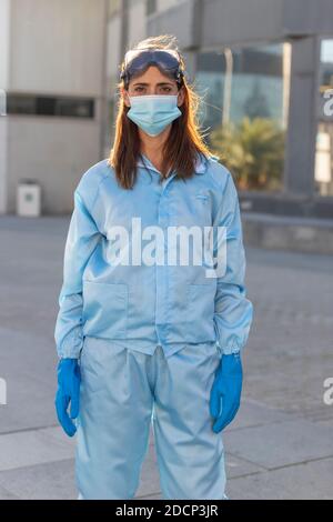 Female doctor at the emergency door of the hospital, against COVID19 Stock Photo