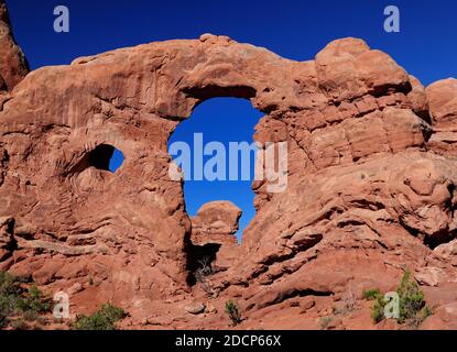 View Through Turret Arch Arches National Park Utah On A Sunny Summer Day With A Clear Blue Sky Stock Photo