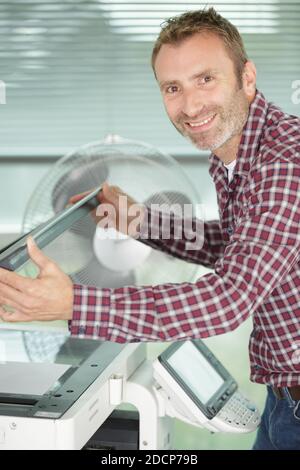 man using scanner multifunction device in office Stock Photo