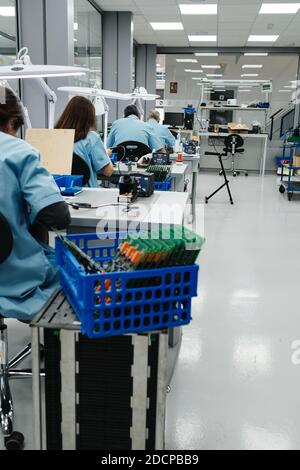 several workers make the products on their work table Stock Photo