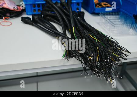 collection of black, green and yellow cables on a table Stock Photo