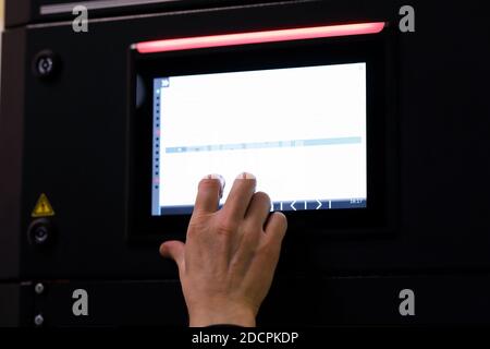 Working with a touch screen control panel of industrial equipment. Selective focus. Stock Photo