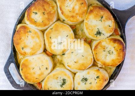 Top view of Chicken Pot Pie with biscuits used on top cooked to a toasty golden brown in a cast iron skillet. Stock Photo
