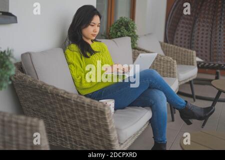 Young asian woman, freelancer , working on her laptop. Distance learning or remote work concept. High quality photo Stock Photo