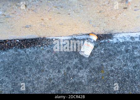 Empty Naloxone HCL vial left on the ground; opioid antagonist used for the treatment of known or suspected opioid overdose; opioid effect blocker. Stock Photo