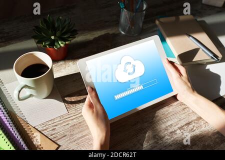 Cloud synchronization progress bar on tablet screen. Data storage and protection. Technology and internet concept Stock Photo