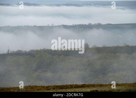 Morning mist defiling over the foggy hills Stock Photo