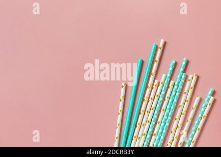 Biodegradable drinking straws for party isolated on pink background. Top view flat lay. Copy space. Stock Photo