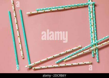 A frame of Drinking paper straws for cocktails on pink background. Top view flat lay. Copy space. Stock Photo