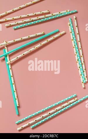 A frame of Drinking paper straws for cocktails on pink background. Top view flat lay. Copy space. Stock Photo