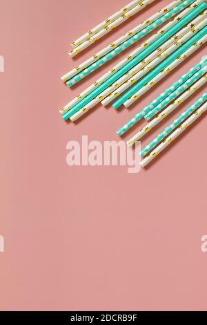 Biodegradable drinking straws for party isolated on pink background. Top view flat lay background. Copy space. Stock Photo