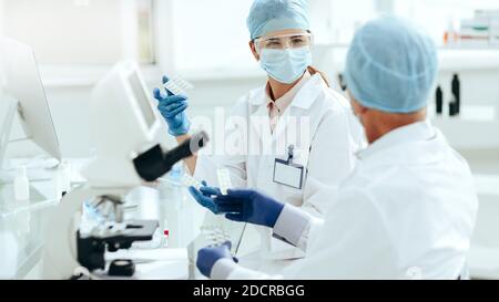 scientists are conducting research on a new drug . Stock Photo