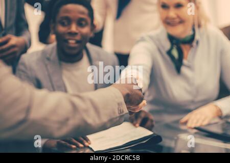 close up. smiling international business partners shaking hands Stock Photo