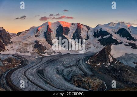 The summits of Piz Cambrena, Piz Palü and Bella Vista and the upper part of Pers Glacier, seen from Munt Pers near Diavolezza at sunset. Stock Photo