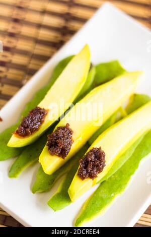 Sliced green mango with bagoong popular in the Philippines Stock Photo