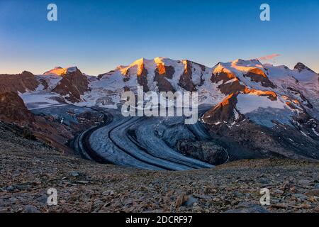 The summits of Piz Cambrena, Piz Palü and Bella Vista and the upper part of Pers Glacier, seen from Munt Pers near Diavolezza at sunrise. Stock Photo