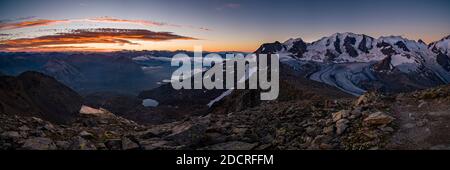 The summits of Piz Palü, Bella Vista, the upper part of Pers Glacier and the valley Val Bernina, seen from Munt Pers near Diavolezza at sunrise. Stock Photo