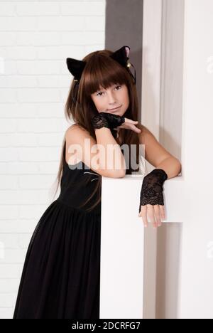 Portrait of cute teen girl disguised as a kitten. Stock Photo