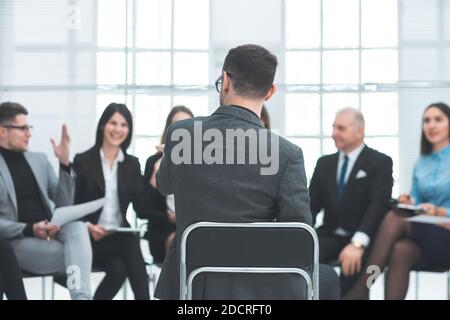 employees asking questions at a meeting with the project Manage Stock Photo