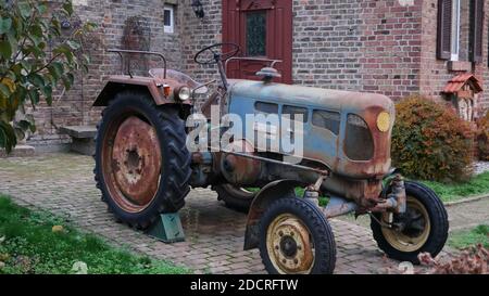 Old-fashioned, aged tractor with rusty metal from former times Stock Photo