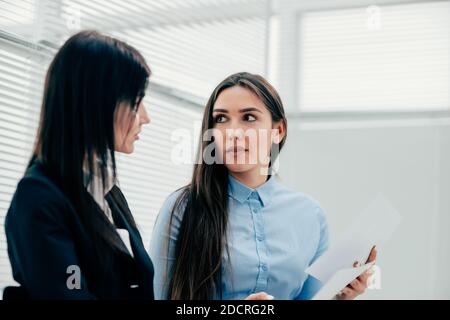 two young employees discussing business documents. photo with copy-space Stock Photo