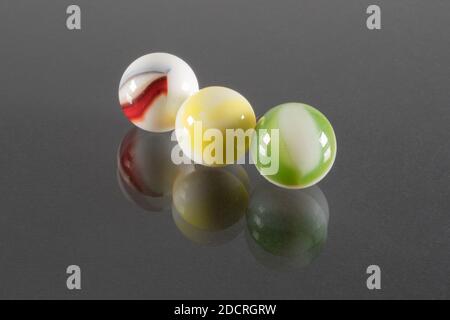 Three Small White Ceramic Balls with Veins and Black Background. Stock Photo