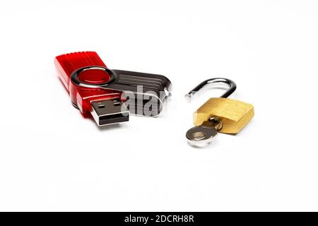Flash drive and padlock, close-up on a white background. Hacking and data security concept Stock Photo