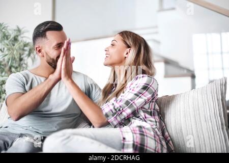 young couple giving each other a high five Stock Photo