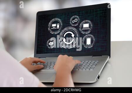 Woman using a laptop with system update concept on the screen Stock Photo