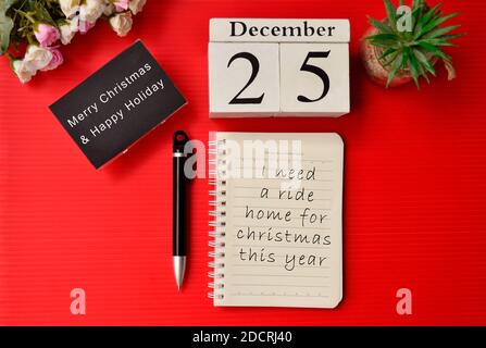 Christmas message written on notepad with with white cube number and month background. Merry Christmas concept Stock Photo