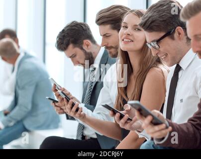 group of diverse young people sitting in the office lobby Stock Photo