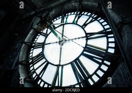 Interior of old big tower with close-up on clock face mechanism inside brick space Stock Photo