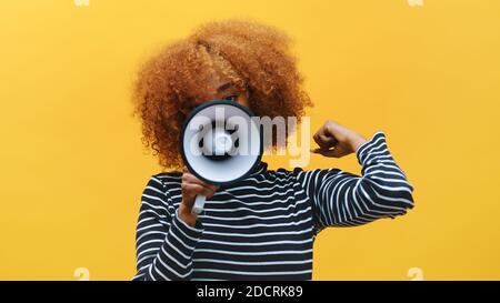 African american black woman with curly hair shouting into the megaphone. High quality photo Stock Photo
