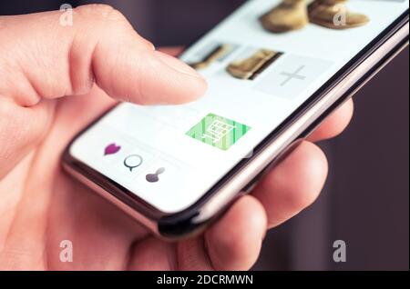 Online shopping and fashion store website with add to cart button in mobile phone. Customer order and purchase product on internet site. Stock Photo