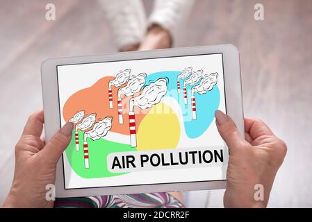 Air pollution concept shown on a tablet held by a woman Stock Photo