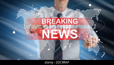 Man touching a breaking news concept on a touch screen with his fingers Stock Photo