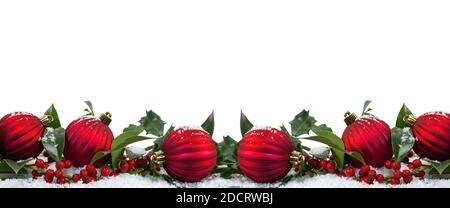 Wide Christmas border with red baubles and berries isolated on white background. Stock Photo