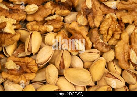 Pistachios and walnuts lie on the sacking. Close up Stock Photo