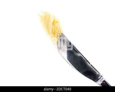 Knife with butter isolated on white background Stock Photo
