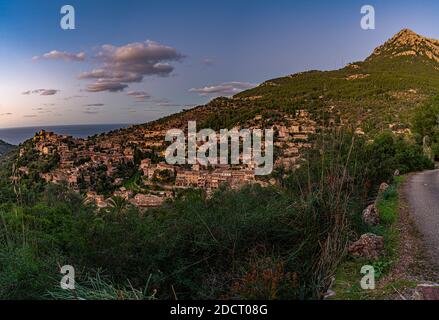 Beautiful view of the town of Deia, located in the Sierra de Tramuntana, a world heritage site, in Mallorca, Spain. Stock Photo