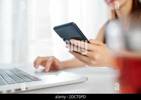 Female entrepreneur checking notifications Stock Photo