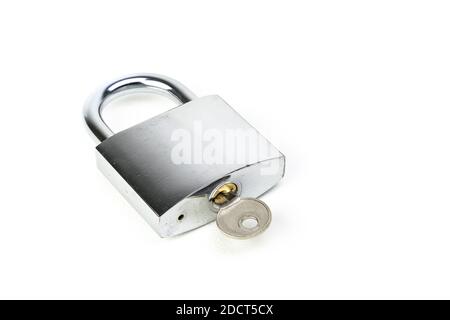 closeup on hardened steel padlock with hand and key on white background Stock Photo