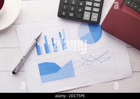 financial graph, calculator and notepad on table  Stock Photo
