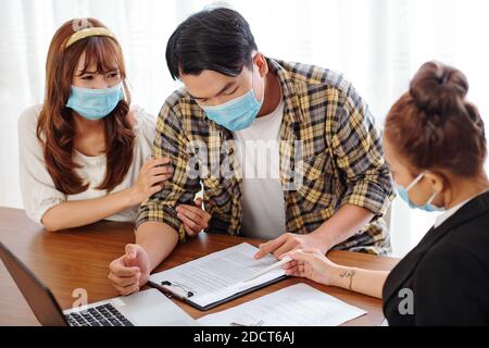 Couple reading rental lease agreement Stock Photo