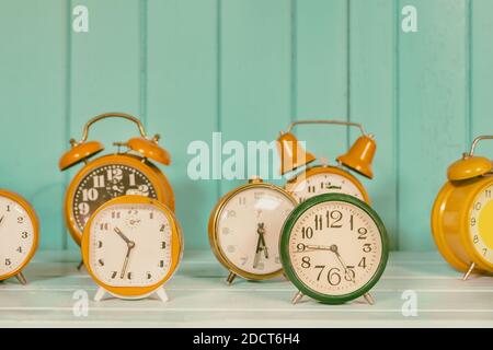 Retro styeled image of a set of different colorful alarm clocks Stock Photo